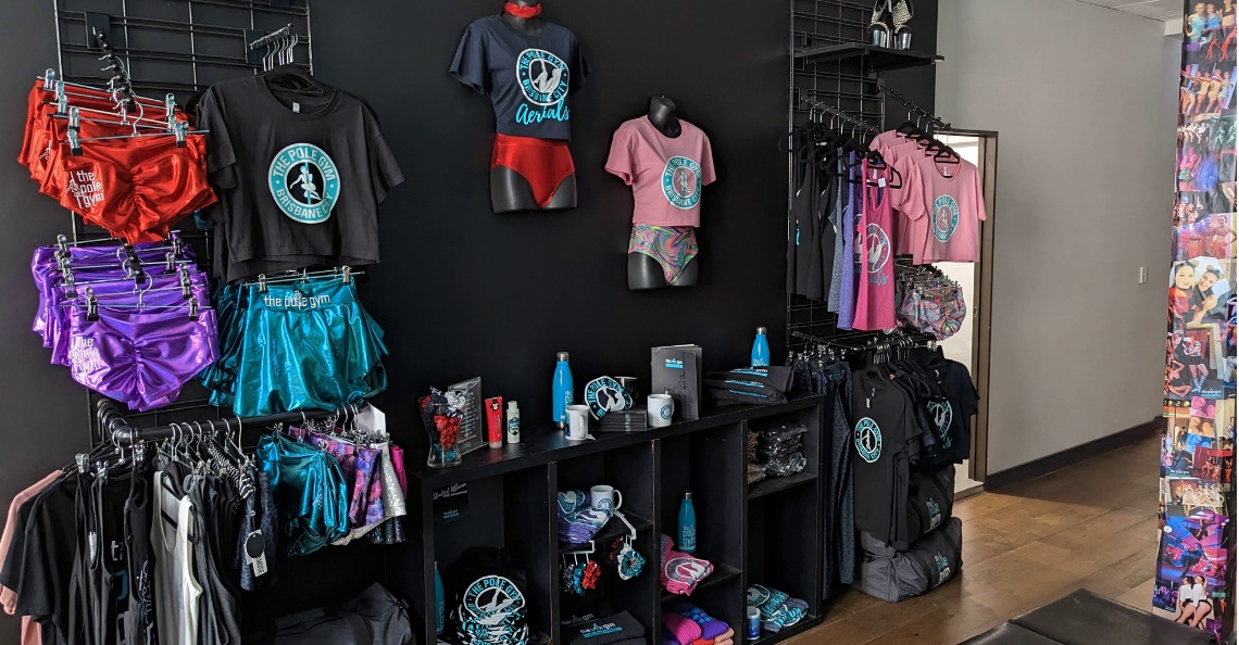 The Pole Gym Brisbane City Merchandise Wall. We sell pole wear including hot pants, crop tops, hoodies, bags and more!