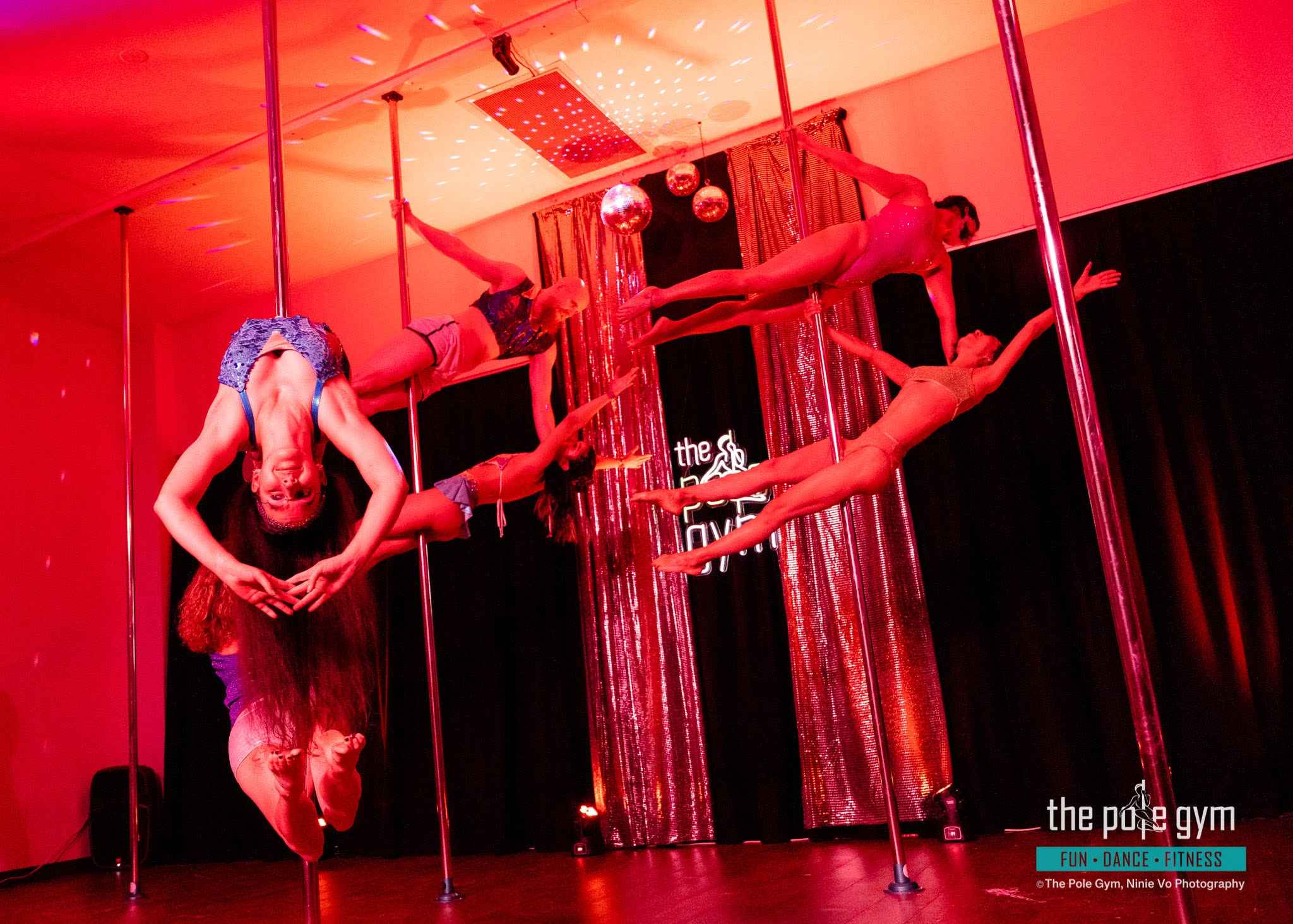 Doubles tricks display from our advanced pole students in the 70's Grads Show. The Pole Gym Brisbane City.
